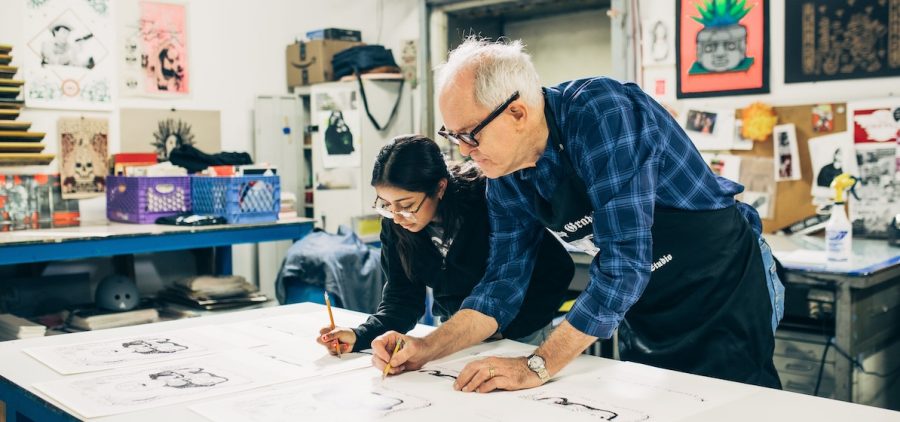 Yoli and John work together in an artists studio, on a screen print drawing at Self Help Graphics.