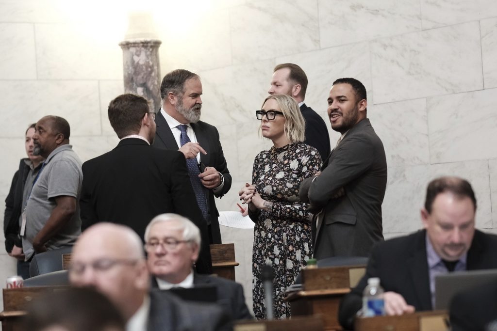 West Virginia state Rep. Kayla Young, D-Kanawha, speaks with colleagues in the House Chambers at the Capitol in Charleston, W.Va.