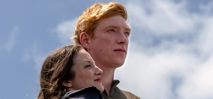Andrea Riseborough as Alice and Domhnall Gleeson as Jack. Hugging with blue sky in the background