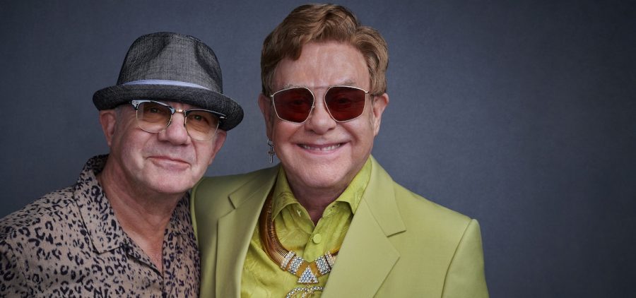 Bernie Taupin and Elton John, The Library of Congress Gershwin Prize for Popular Song 2024 honorees. Elton John in lime green suit and red glasses, Bernie in hat and brown shirt