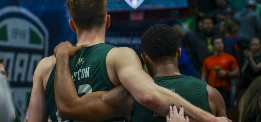 AJ Clayton and Jaylin Hunter hug on the court after Ohio's loss in the MAC Tournament Semifinals