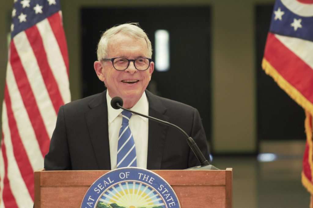 Ohio Governor Mike DeWine smiles while delivering a speech at Athens High School.