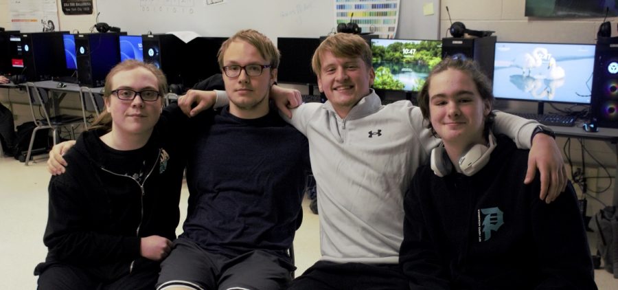 Four members of Morgan High School's championship-winning League of Legends team pose for a photo in the interactive media classroom.