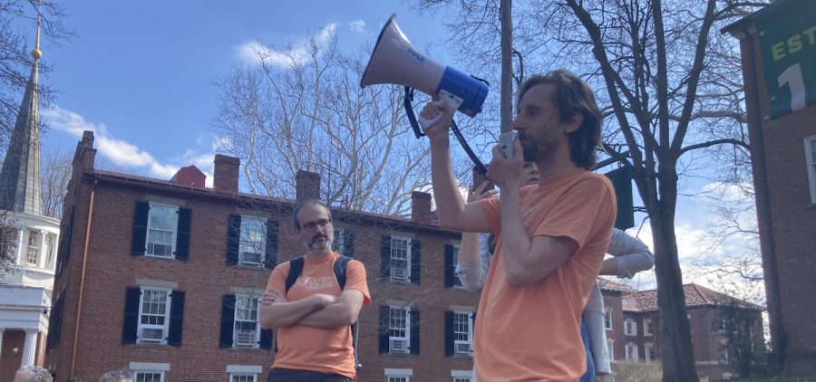 Kyle Butler, an associate professor of instruction at Ohio University, addresses a pro-union rally as Matthew deTar, an assistant professor of communications, looks on.