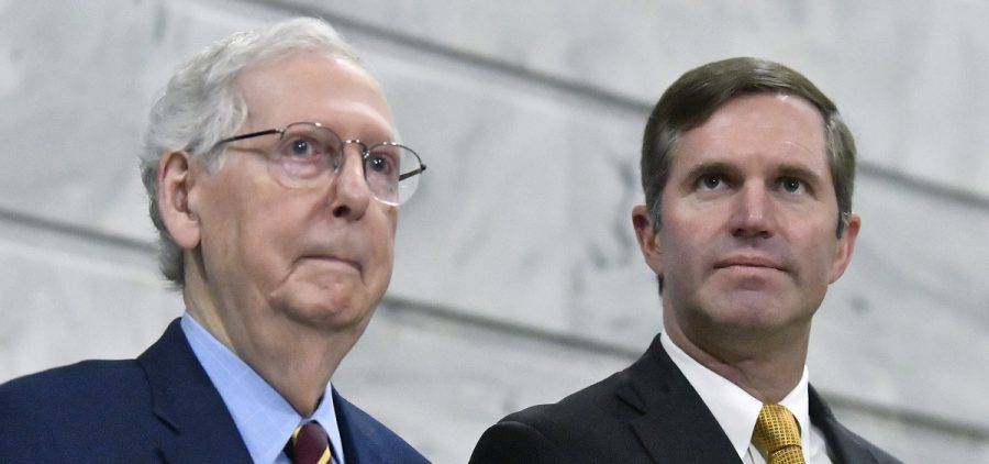 Senate Minority Leader Mitch McConnell, R-Ky., left, stands with Kentucky Gov. Andy Beshear, right, during a ceremony in the Rotunda at the Kentucky State Capitol in Frankfort
