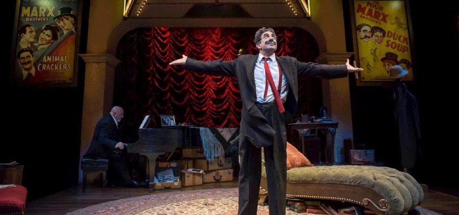 Frank Ferrante playing Groucho with his arms outstretched on stage on Broadway