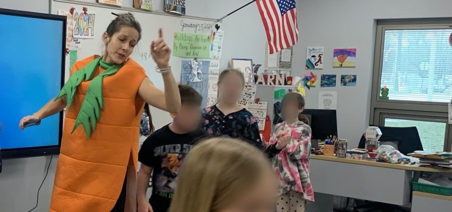 Molly Wales dances in her carrot costume during a smoothie party at the front of the classroom with students at The Plains Intermediate School.