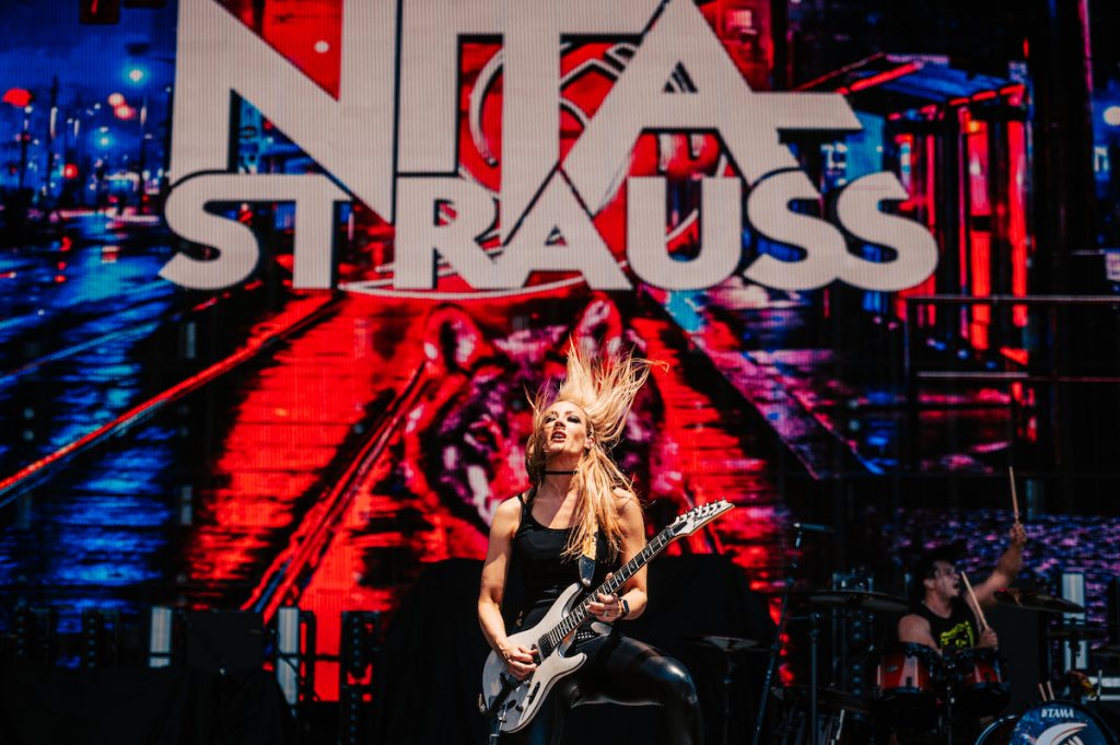 An image of guitarist Nita Strauss playing on stage at the 2024 Sonic Temple Music Festival. 