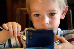 A child using a cell phone.