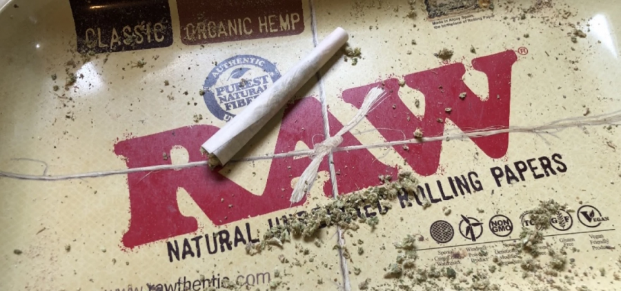 A recreational marijuana joint on a package of rolling papers.