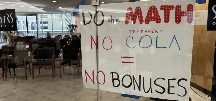 A sign posted by retired teachers attending the State Teachers Retirement System meeting that reads "Do the math, no permanent cola = no bonuses."