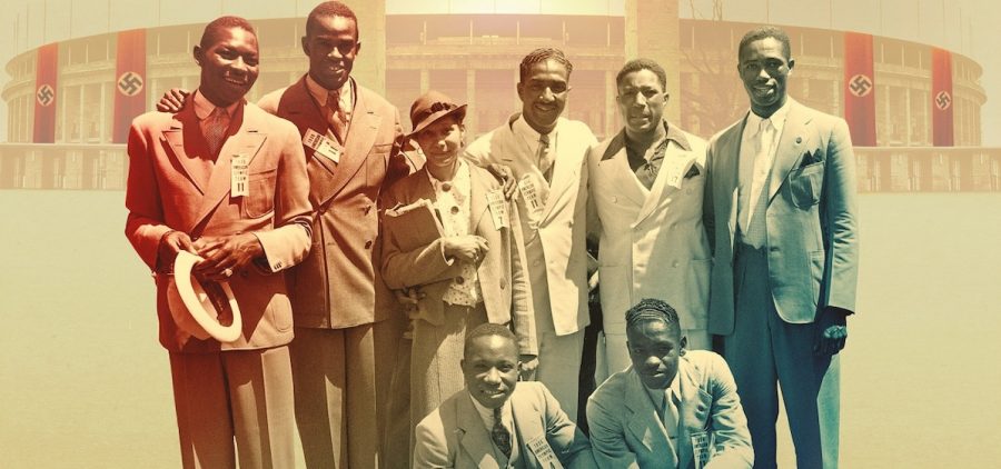 Eight Black men in suits standing in front of stadium draped in Nazi flags