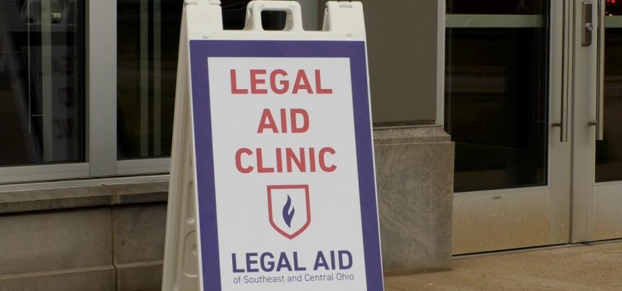 Signage that's posted outside of the Marietta Municipal Court that says "Legal Aid Clinic"