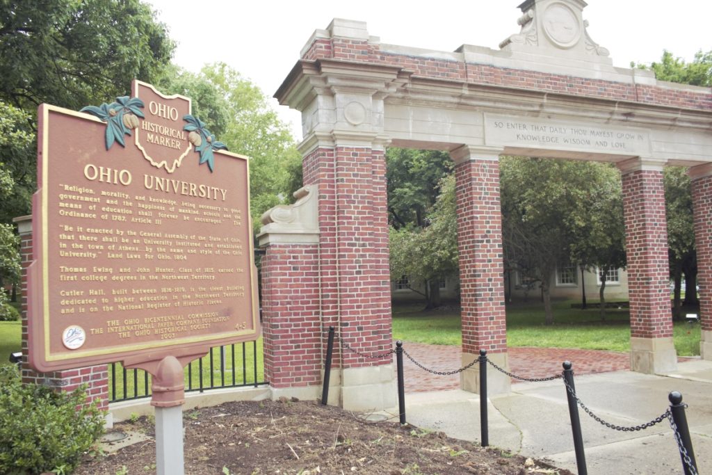 A historical marker celebrates the history of Ohio University outside the gate to the college green.