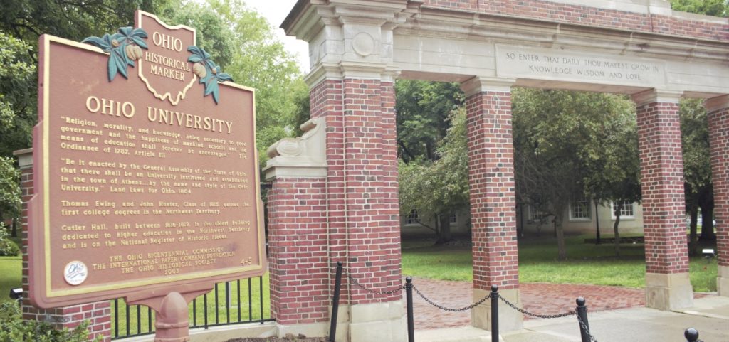 A historical marker celebrates the history of Ohio University outside the gate to the college green.