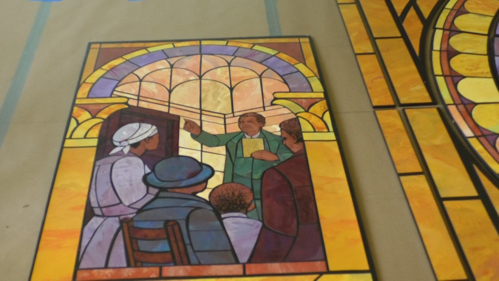 A panel from a new mural at Mount Zion Baptist Church in Athens pictures a gathering in a home where the church began.