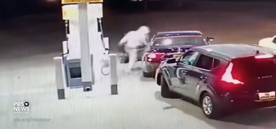 A security camera shows a man entering a vehicle at a gas station with the intention of stealing it.