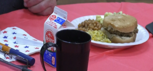 A box of milk and a plate with a burger, corn and beans served at the senior cookout. [Betty Kankam-Boadu | WOUB]