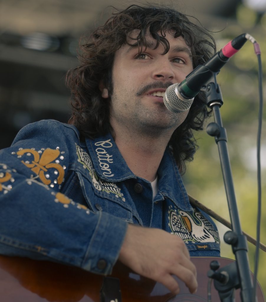 Sean Couture smirks at the audience as he expresses the gratitude and excitment that comes with performing for the Nelsonville Music Festival.