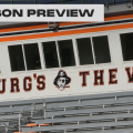 Lettering above the bleachers at Ed Miller Stadium that says "The Burg's the word"