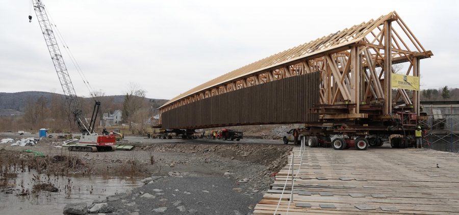 frame of covered bridge on massive trailer bed attempting to be moved