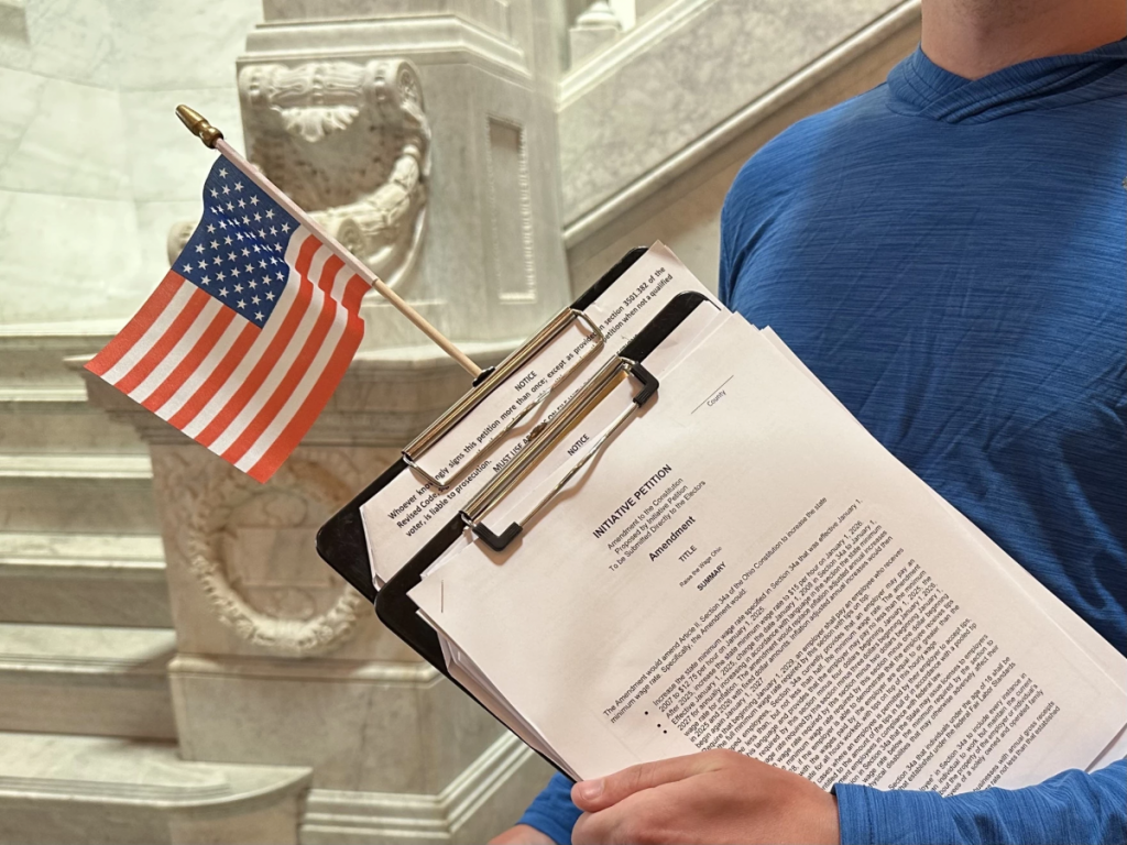 A signature gatherer with Raise the Wage Ohio at the Statehouse.