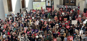 A large crowd gathers outside the statehouse in support of a redistricting initiative.