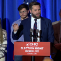 JD Vance speaks at a podium.