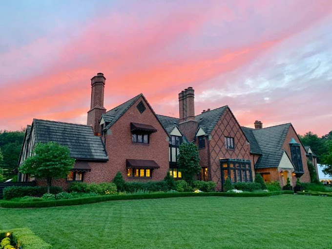 An image of the Zenner House against a pink sky.