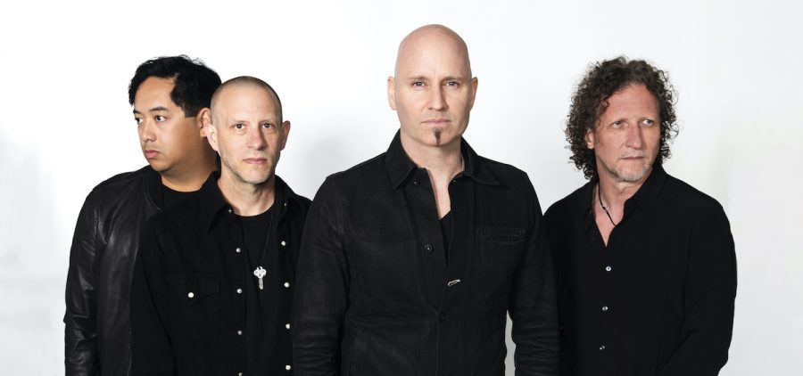 A promotional picture of the band Vertical Horizon. They are posed against a white background and all members are wearing black.