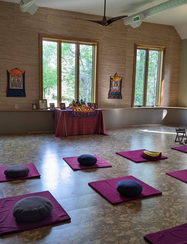 An image of an empty room with meditation mats.