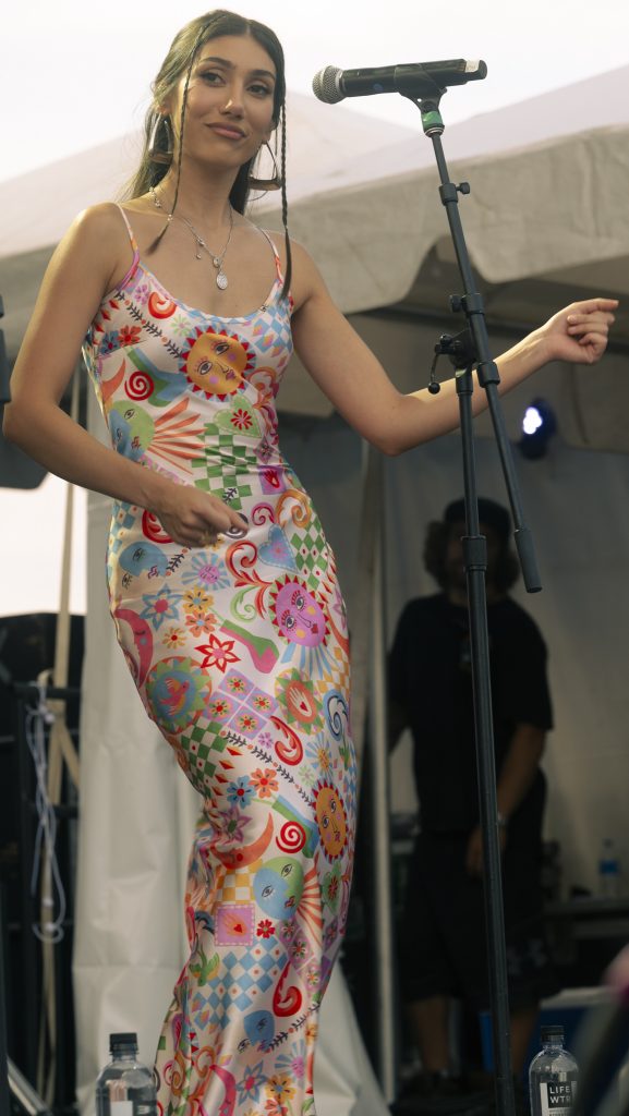 Viane Escobar dances and sings backing vocals for Thee Sacred Souls at the Nelsonville music festival.