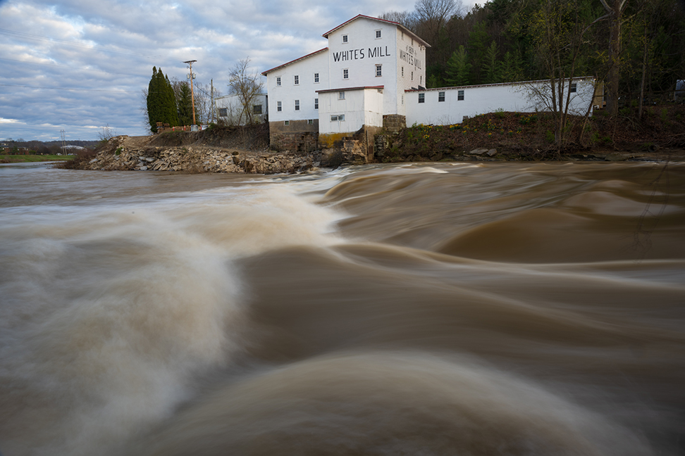 A photo of White's Mill, taken from the POV of the Hocking River below it.