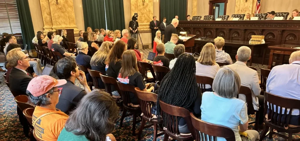 Supporters of a redistricting amendment occupy a hearing room for the Ohio Ballot Board meeting, where the board is scheduled to decide on the wording of the ballot summary that voters will see.