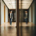 A student walks down a hall in a school.