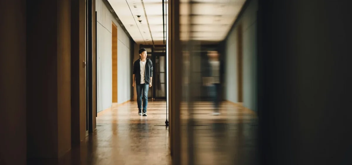 A student walks down a hall in a school.