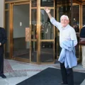 Phil Donahue waves to fans as he leaves his hotel during the Toronto Film Festival.