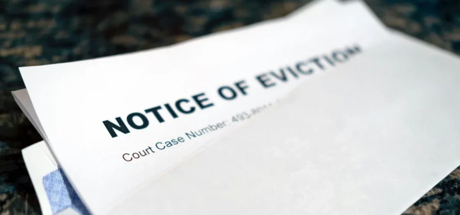 A stack of papers has an eviction notice.