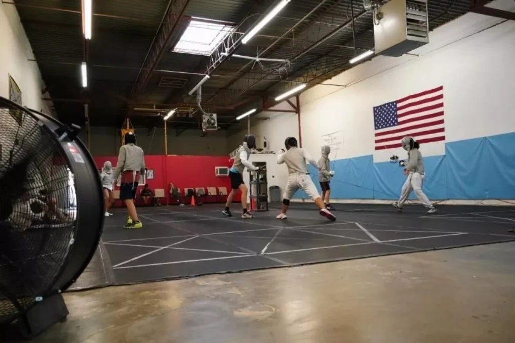 Young fencers train at the Salle du Lion fencing center.