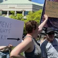 Abortion right supporters block the sign of an abortion rights opponent at a rally at the Ohio Statehouse on May 14, 2022