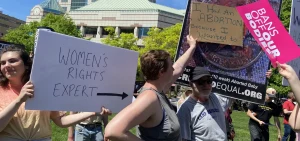 Abortion right supporters block the sign of an abortion rights opponent at a rally at the Ohio Statehouse on May 14, 2022