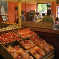 Shelves at a food pantry are stocked with packaged goods and produce.