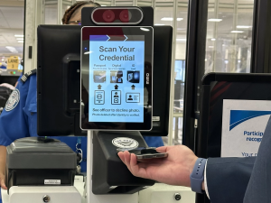 A person scans a digital ID at a TSA check using an iPhone.