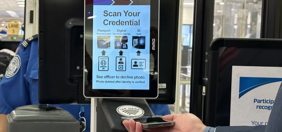 A person scans a digital ID at a TSA check using an iPhone.