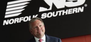 Alan Shaw speaks during an interview Wednesday, June 21, 2023, in Atlanta with the Norfolk Southern logo behind him.