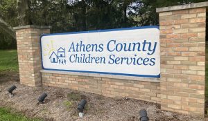 A large sign framed with brick pillars that reads "Athens County Children Services."