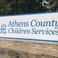 A large sign framed with brick pillars that reads "Athens County Children Services."