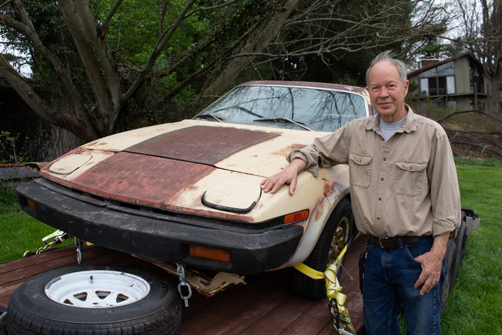 Chris Schermacher with the Triumph TR8 he bought for $1,000.