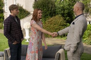 Aiden MacNeil (Will Tudor), Cecily Treherne (Amy Griffiths), Frank Parris (Mark Gatiss) in the garden area. Frank and Cecily shaking hands