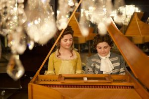 Maria Anna (Alyona Popova) & Wolfgang Mozart (Hugo Gilmovich) practicing the harpsichord. Credit: Alina Gozin'a / © Media Stockade